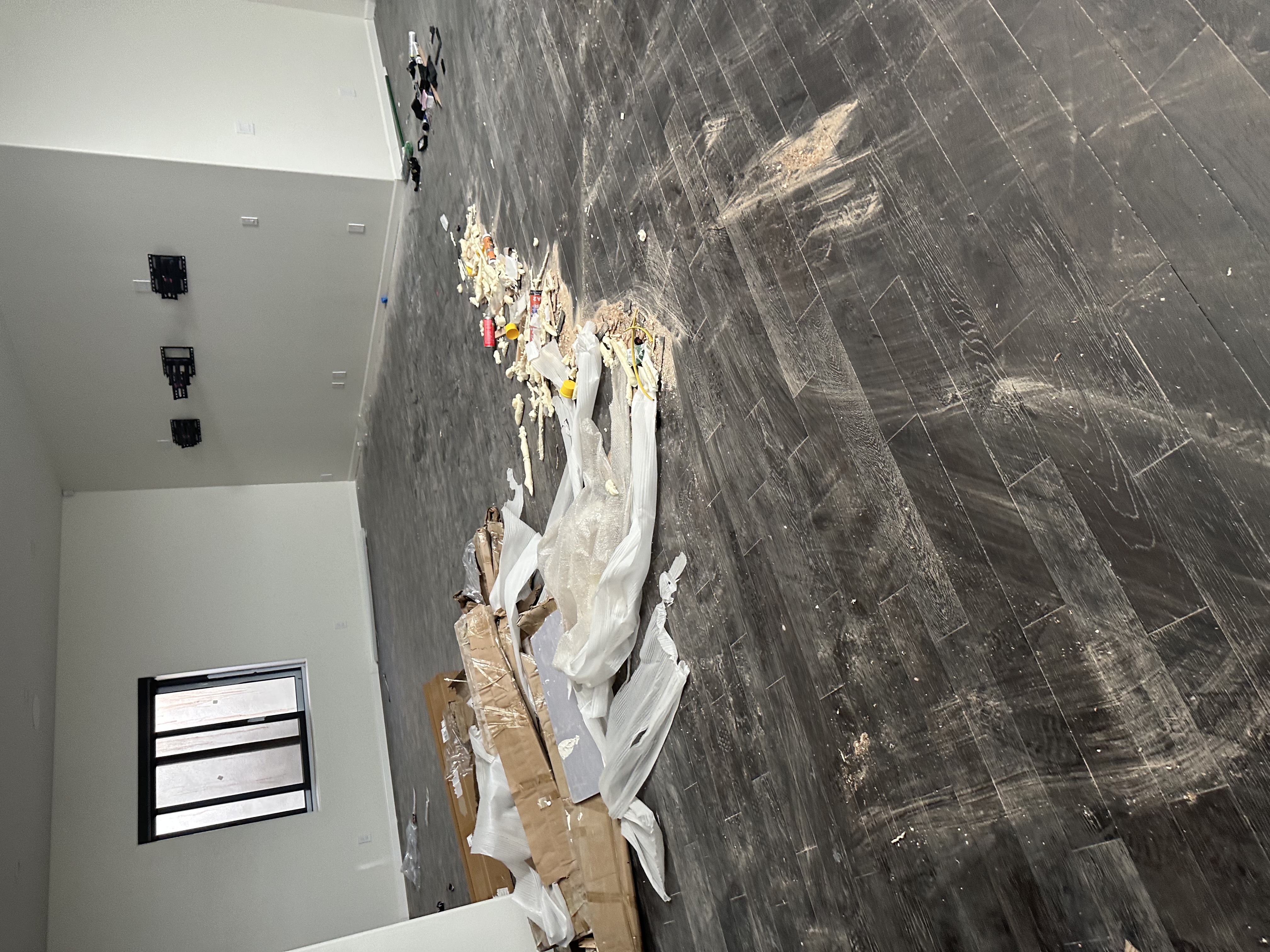 Construction debris on flooring before post-construction cleaning in Phoenix