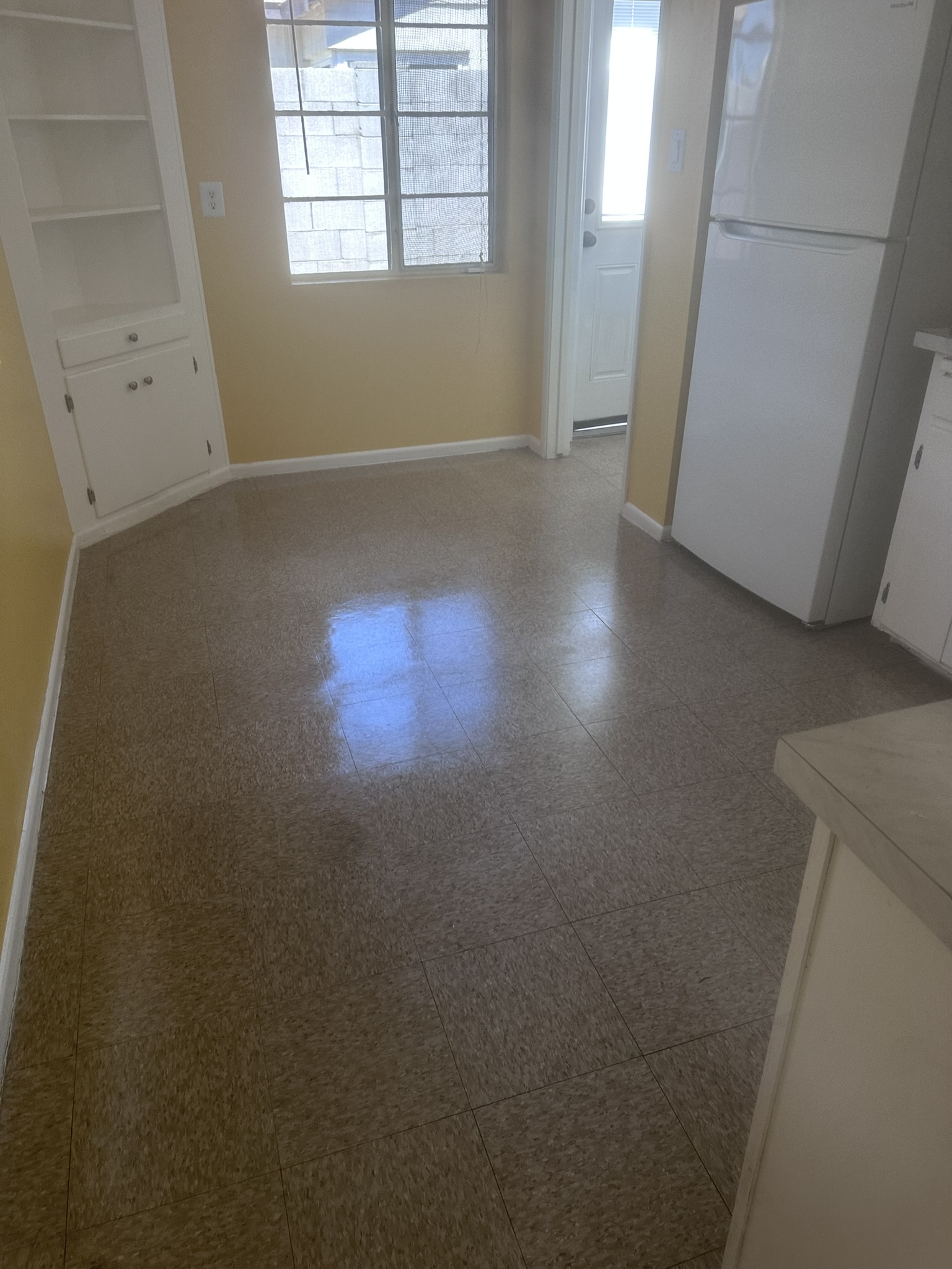 Kitchen VCT floor after strip and wax rental turnover
