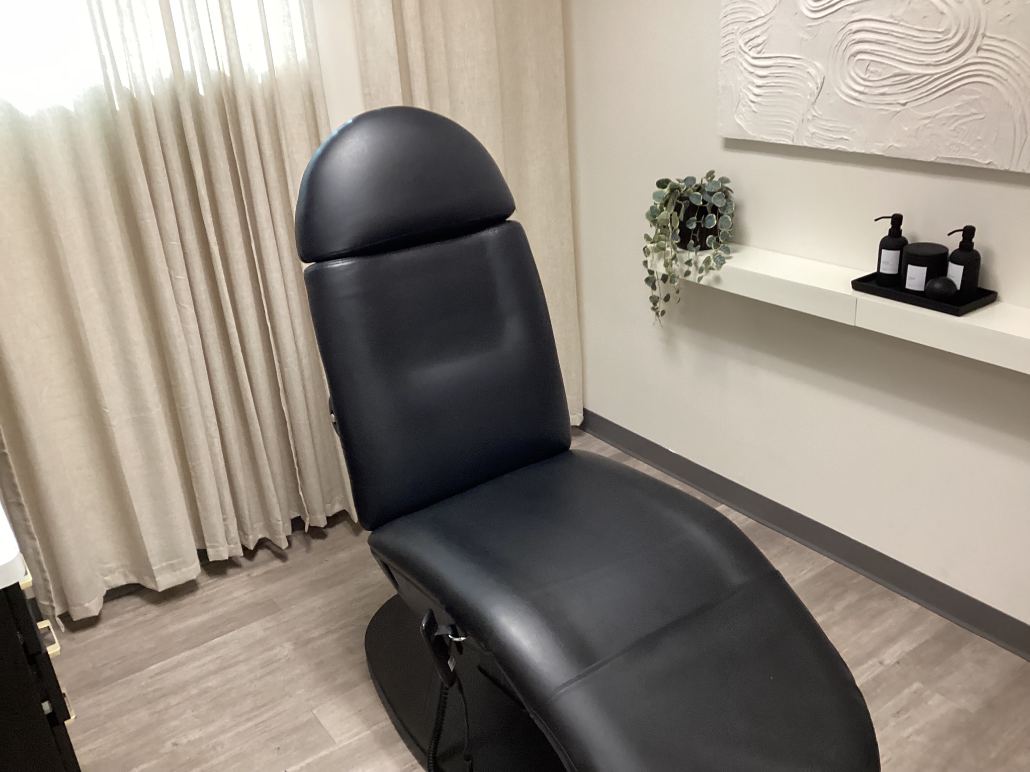 Aesthetic medical treatment room with chair and hard flooring