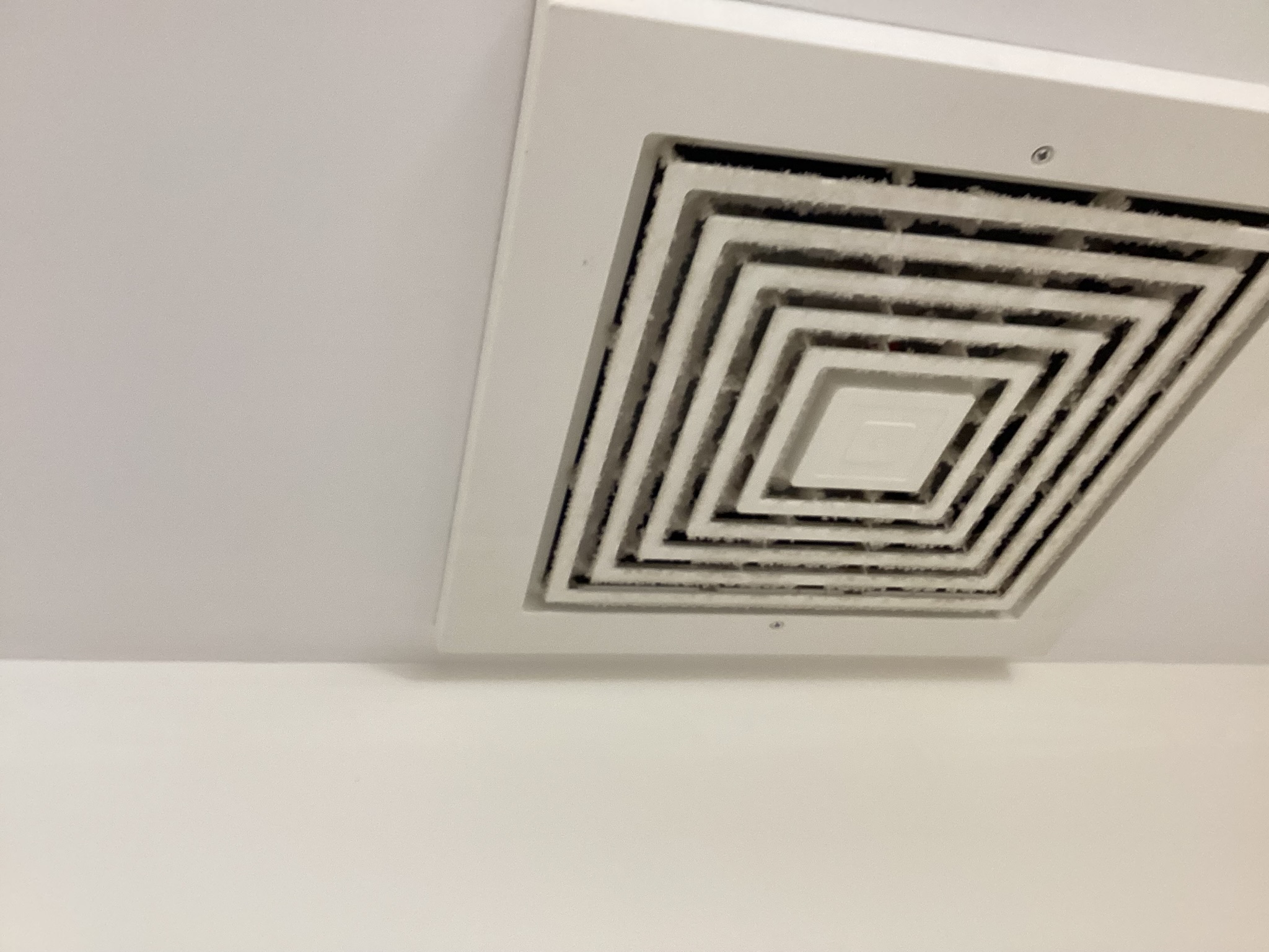 Dust accumulation on accessible ceiling vent in Phoenix medical office
