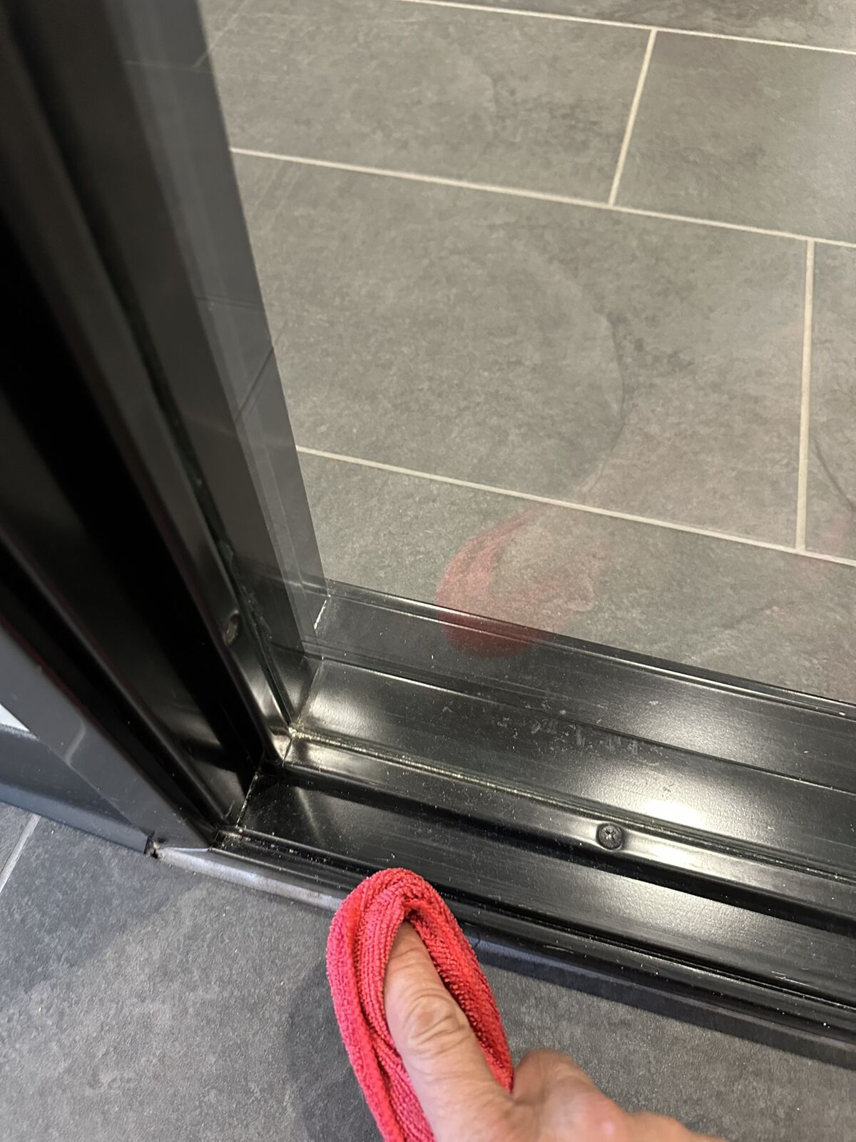 Warehouse door threshold being detailed with microfiber cloth