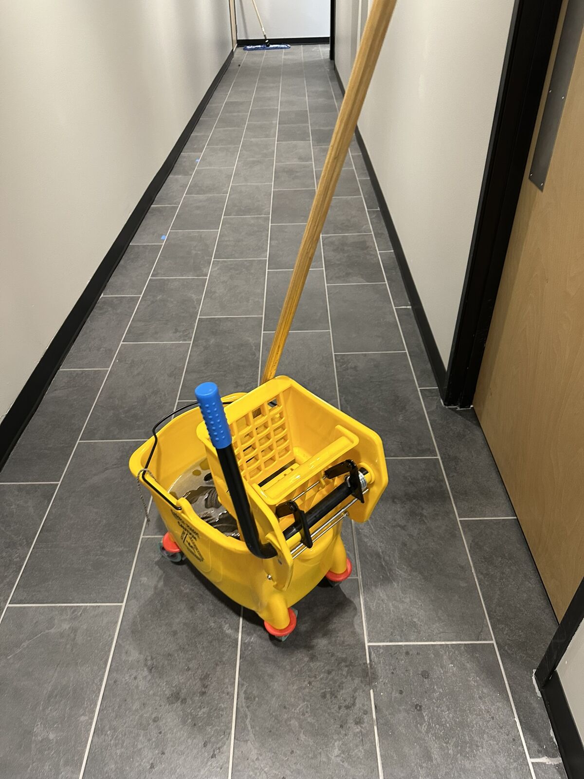 Warehouse hallway hard floor being mopped