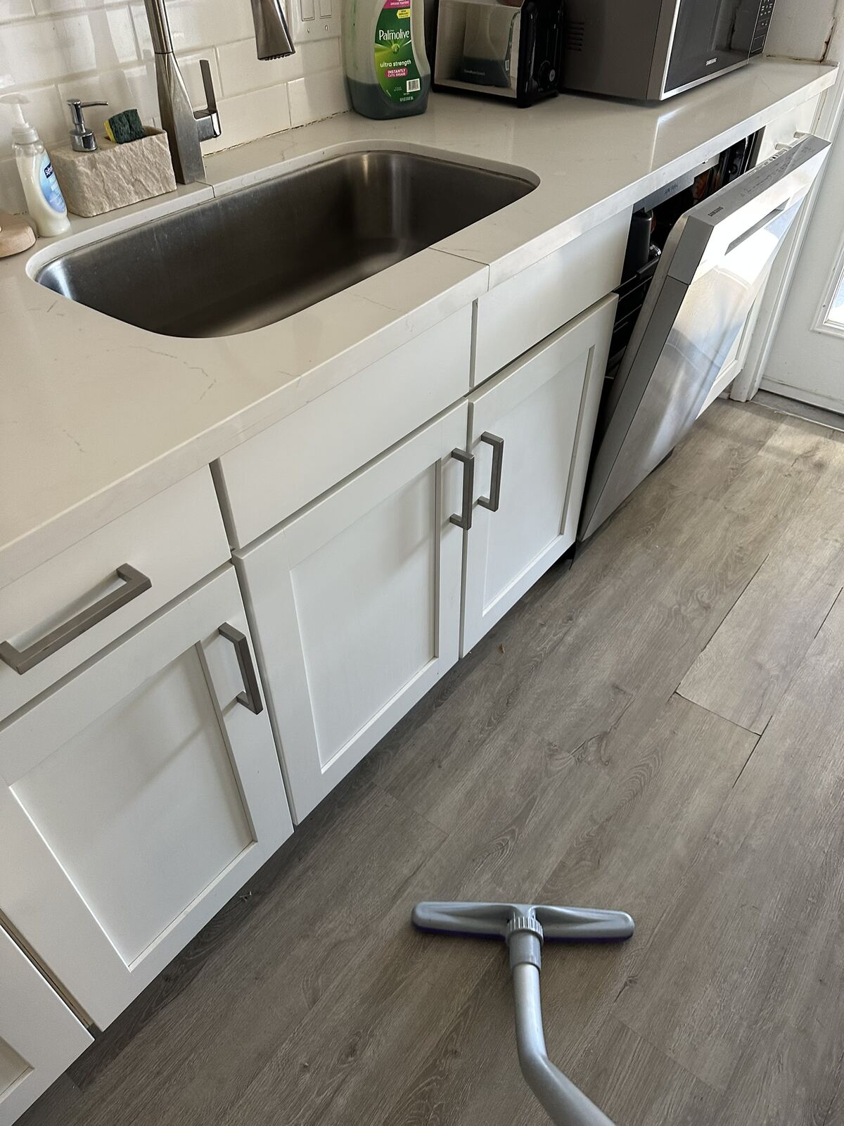 Kitchen sink area checked during turnover cleaning