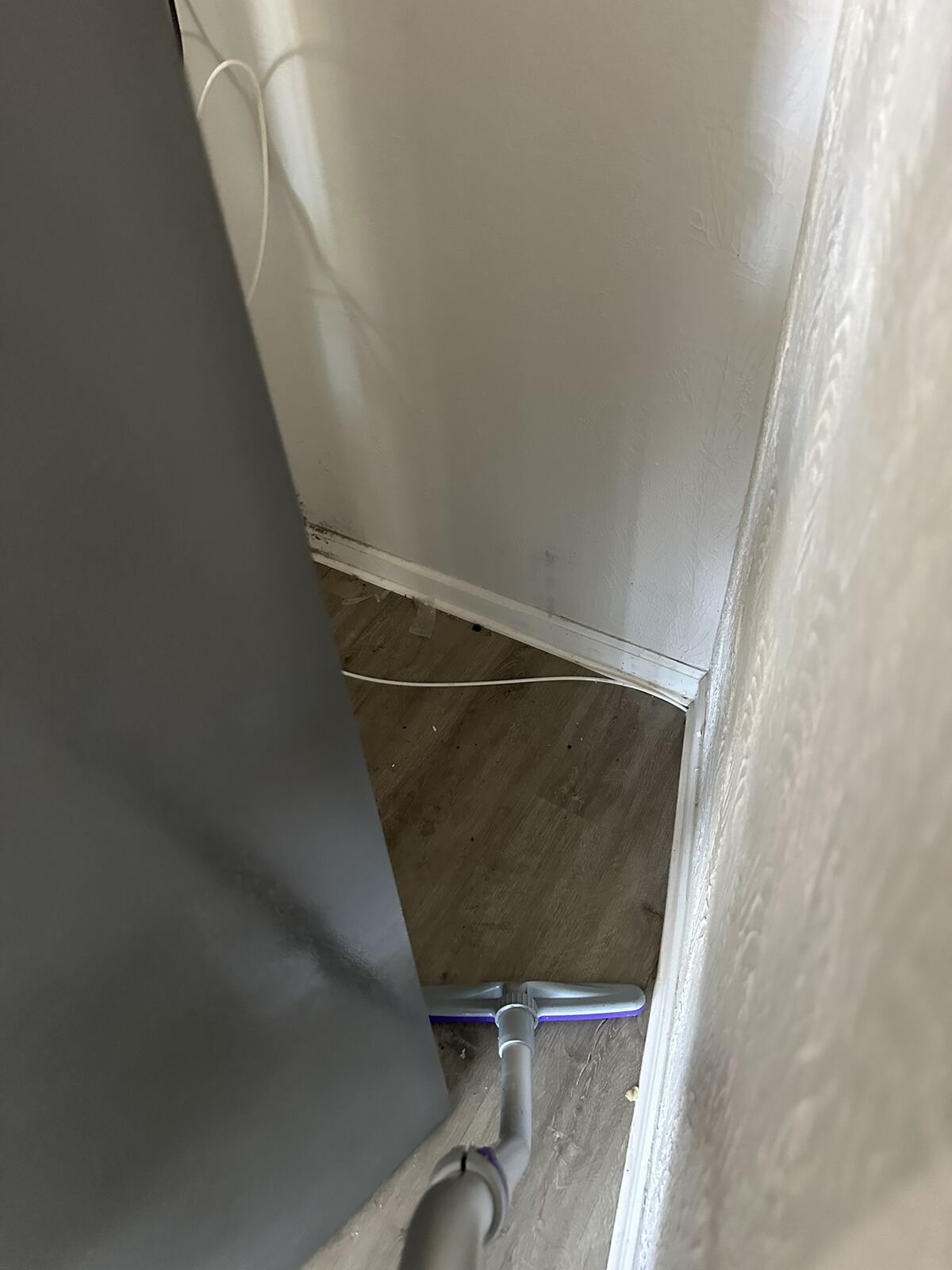 Area around a kitchen appliance checked for debris