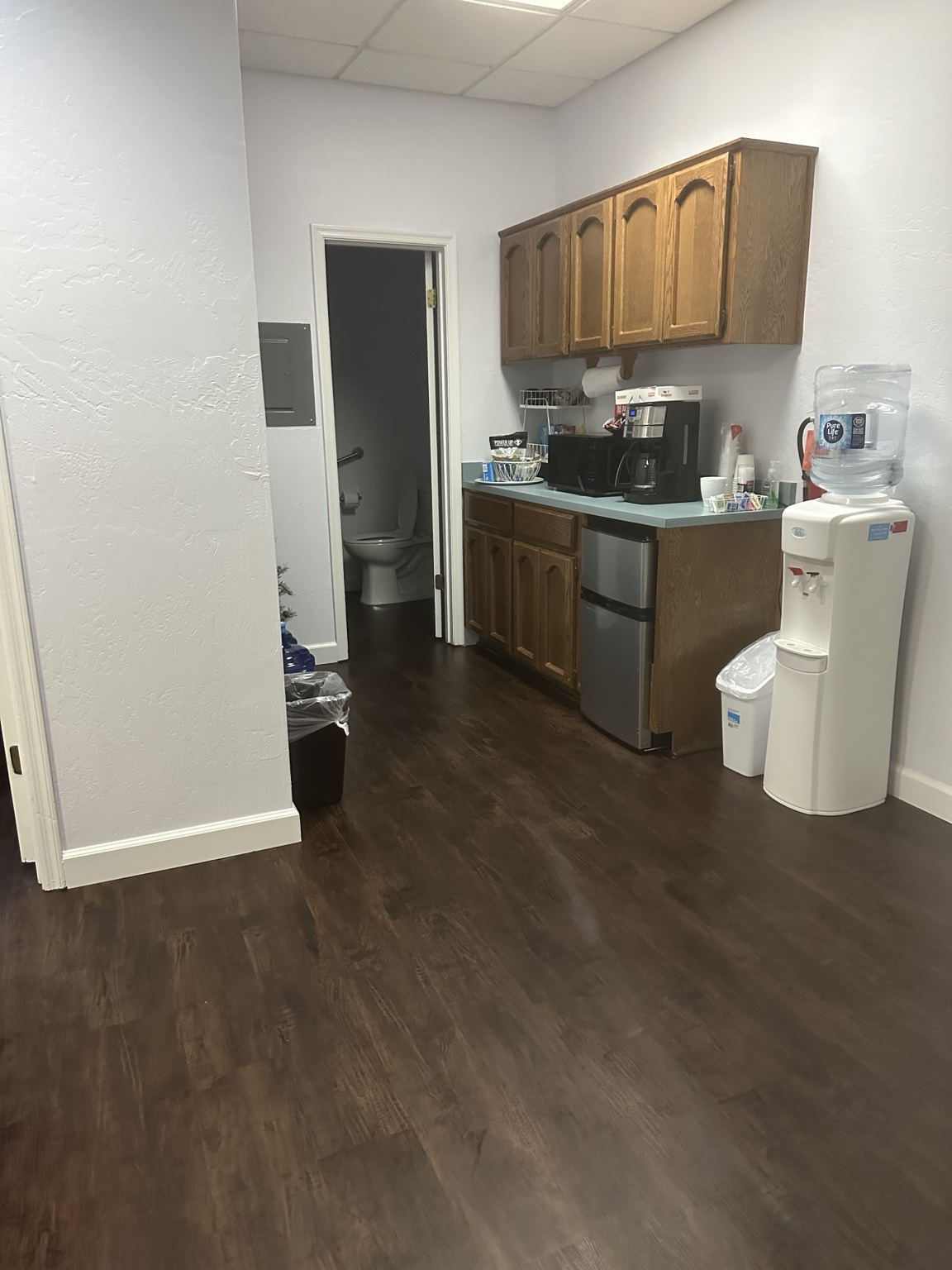 Break room with cabinetry coffee station and water dispenser in a Tempe Arizona office