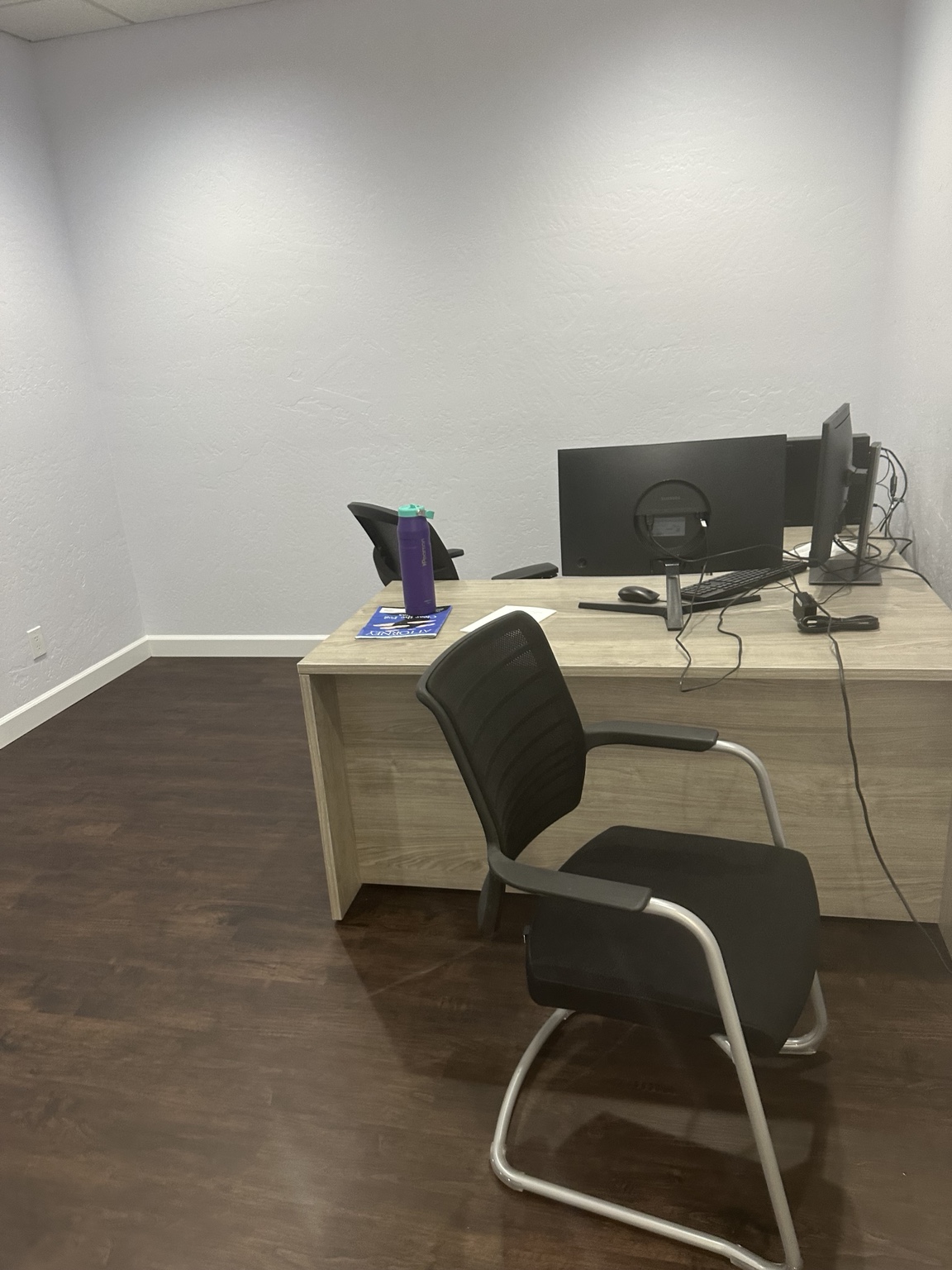Small office with workstation and visitor chair in a Tempe Arizona office