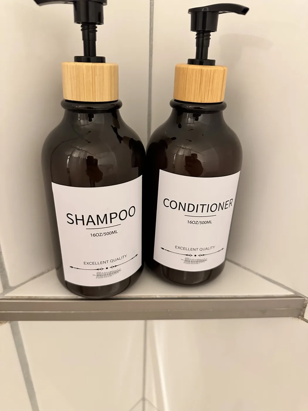 Shampoo and conditioner bottles arranged in shower