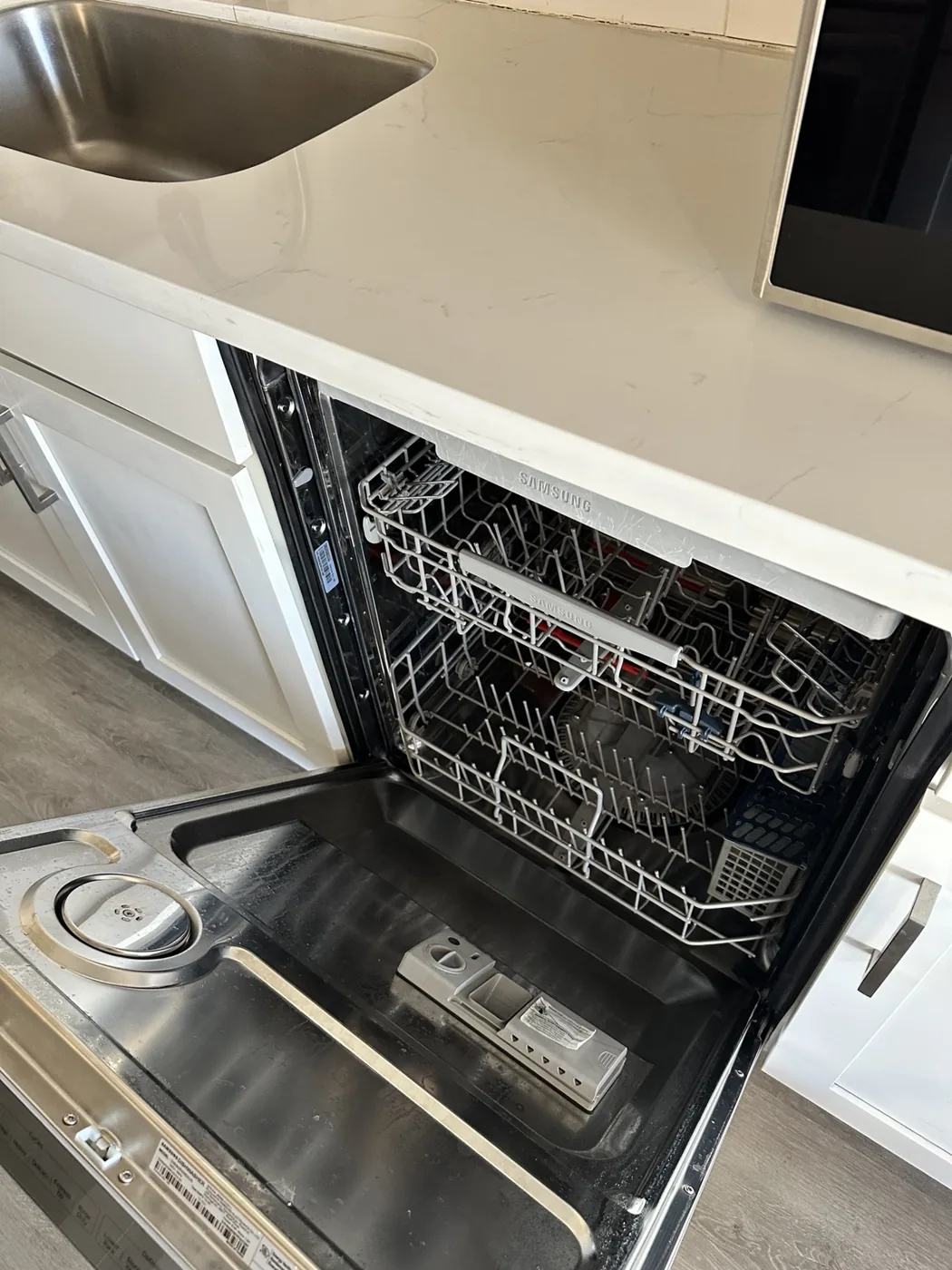 Open dishwasher showing racks and interior