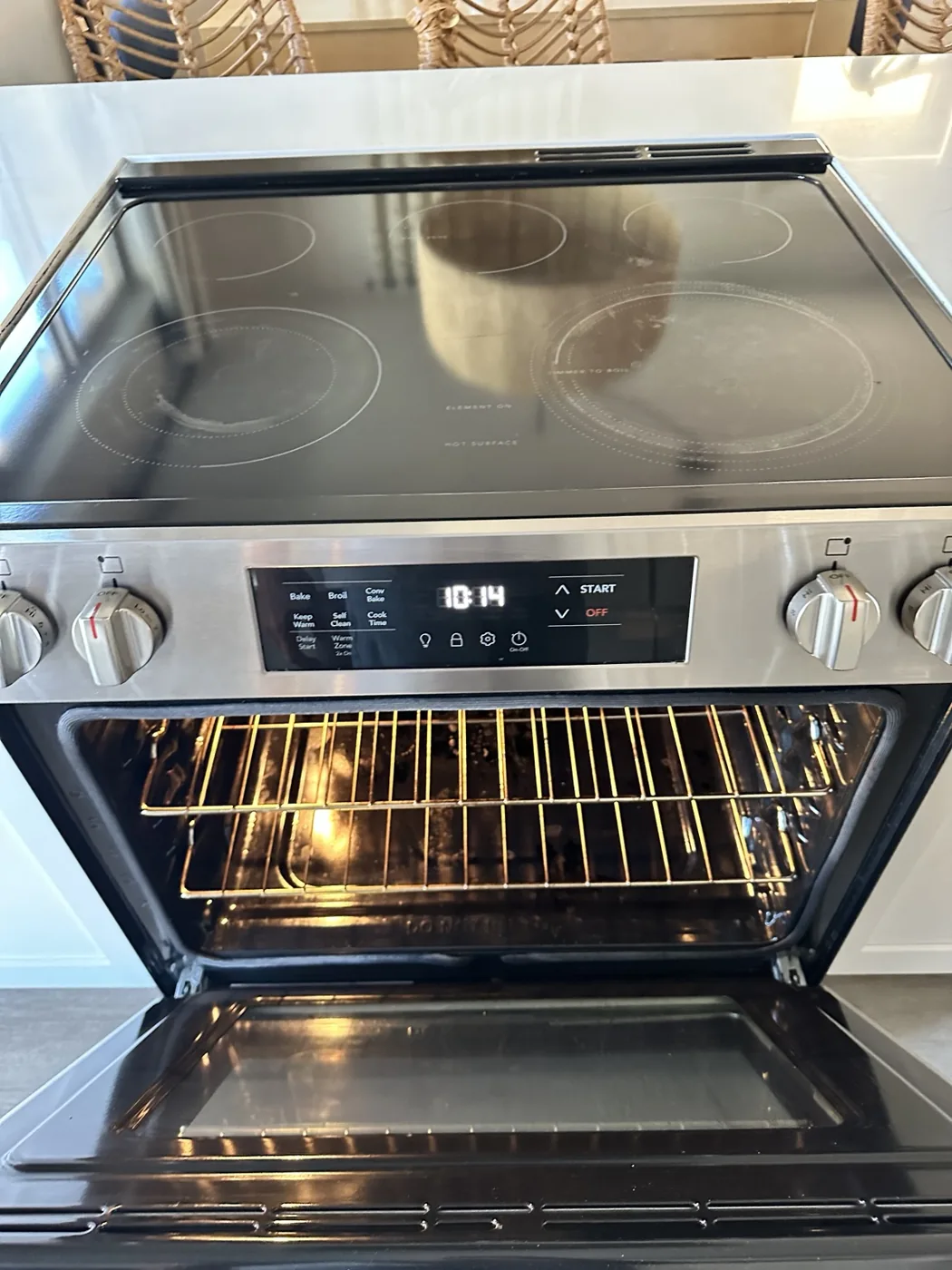 Open oven and cooktop shown during property inspection