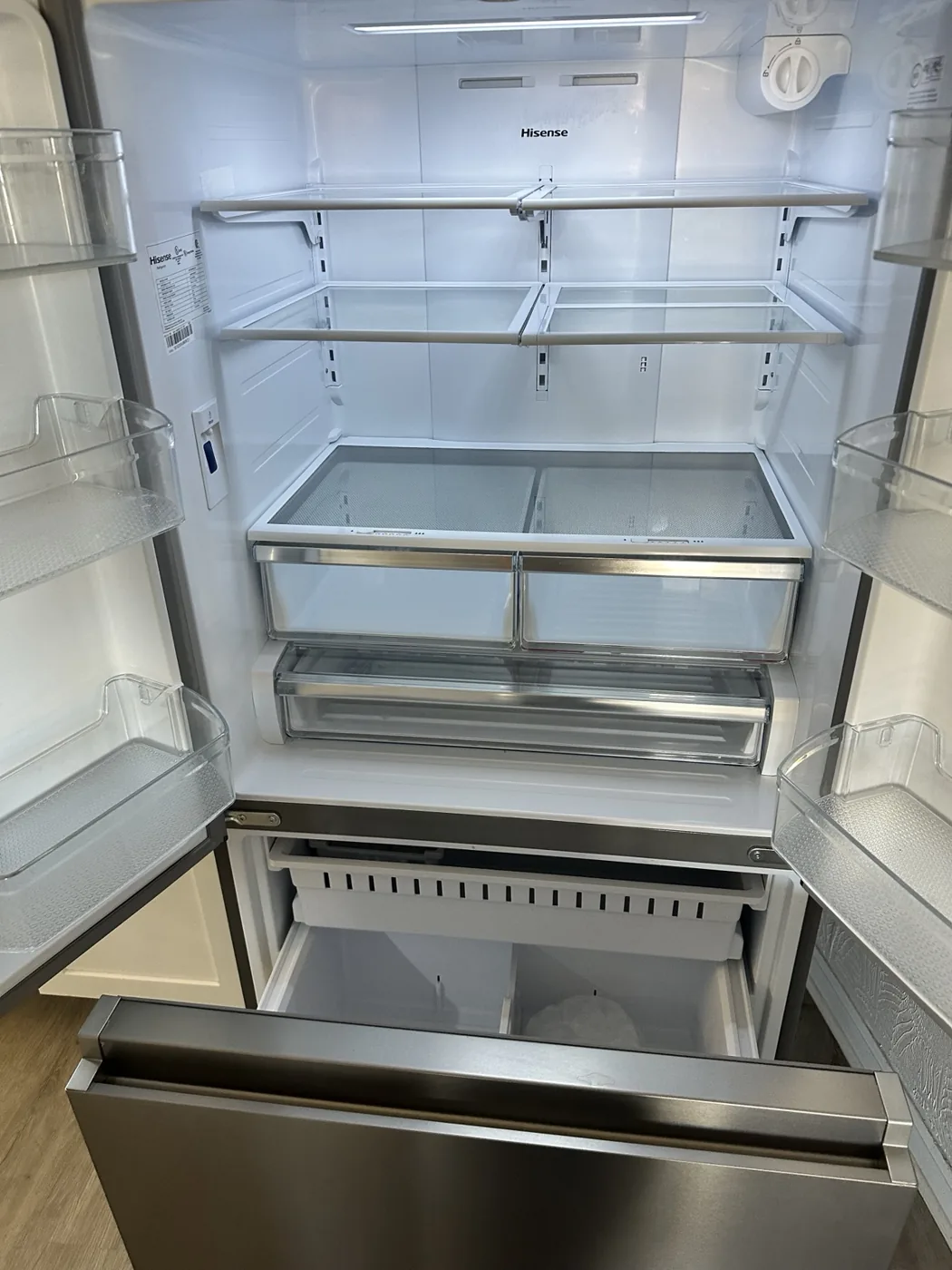 Empty refrigerator with shelves and drawers visible for inspection